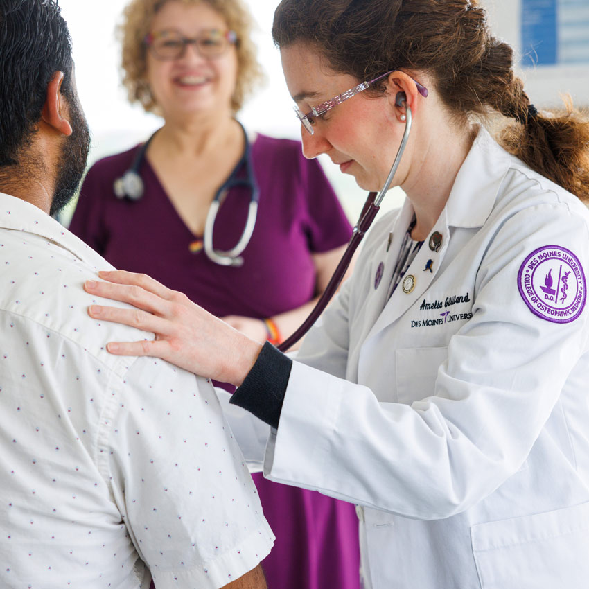 A student at Des Moines University works with a patient at the DMU Clinic.