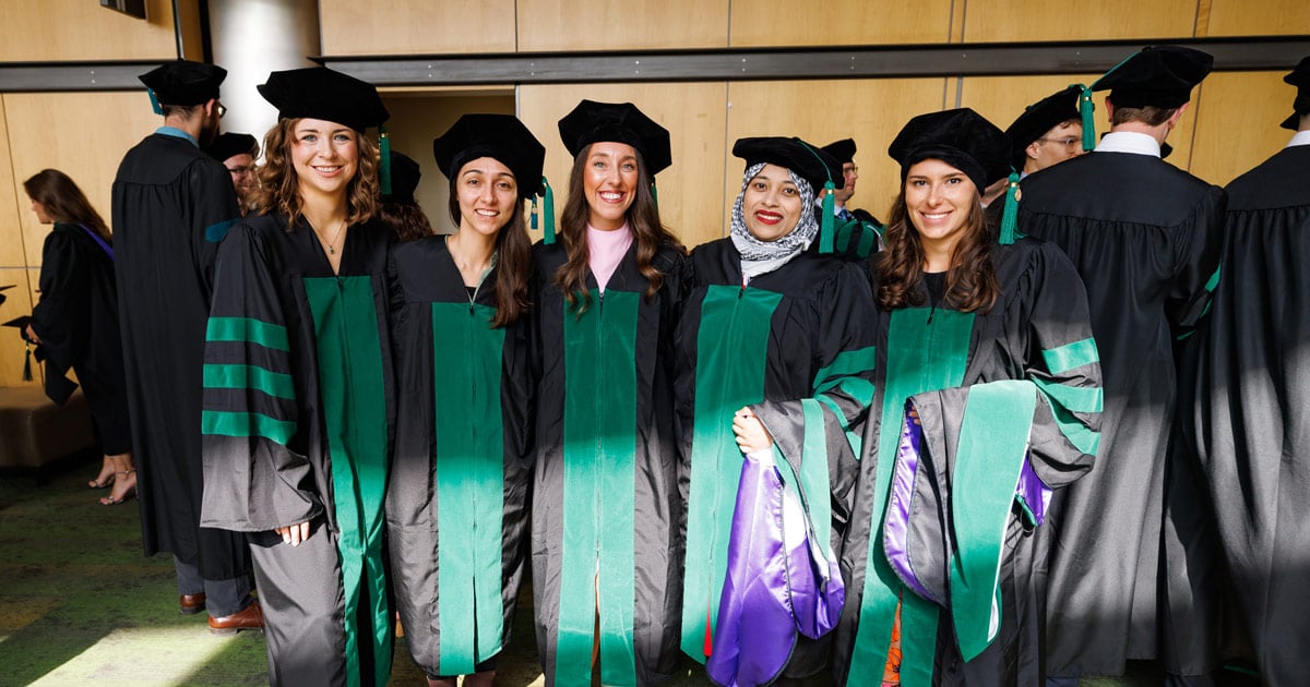 DMU Class of 2024 graduates pose for a photo.