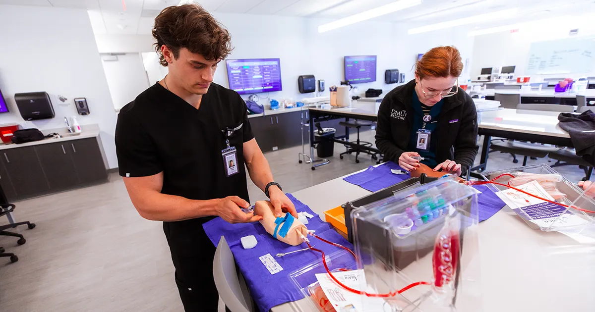 DMU students practice inserting IVs in the Adams Task Training Lab.