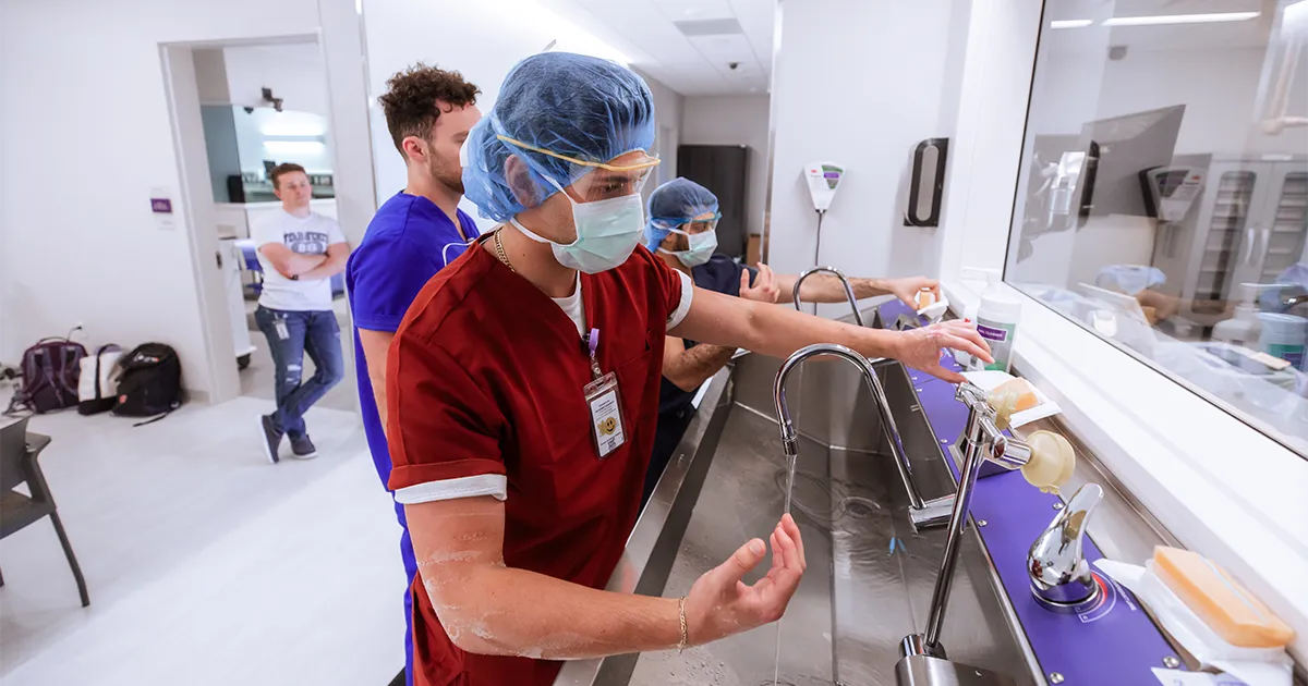 Students practice scrubbing in at the Rakowski Surgical Skills Lab.