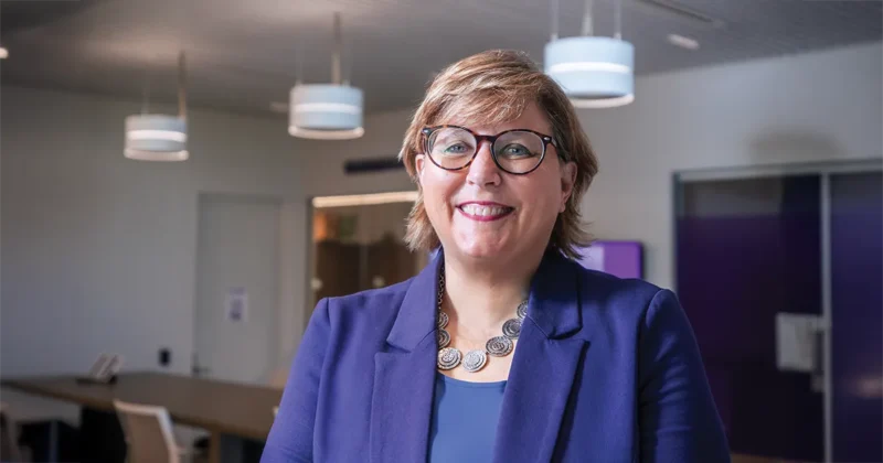 Carolyn Weaver, M.B.A., poses for a photo near the Solutions Hub help desk.