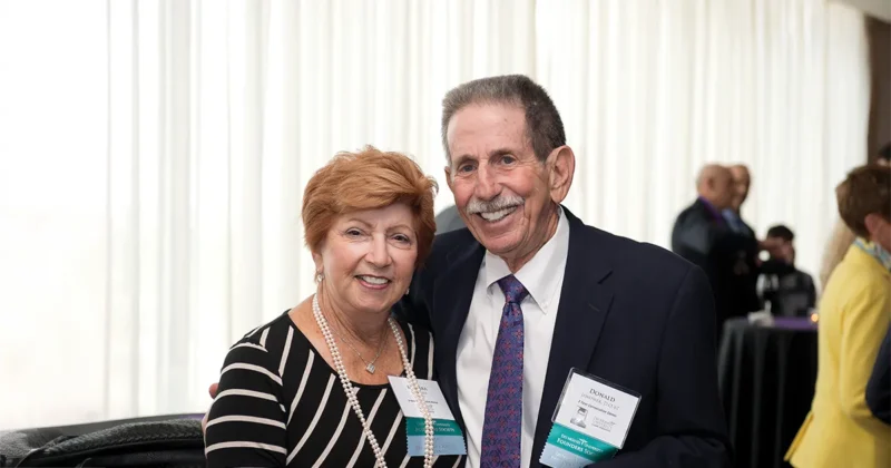 Barbara and Donald Janower, D.O.’67, pose for a photo at a DMU event.