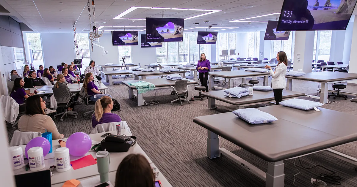 OTD students and faculty discuss course material in the plinth lab.