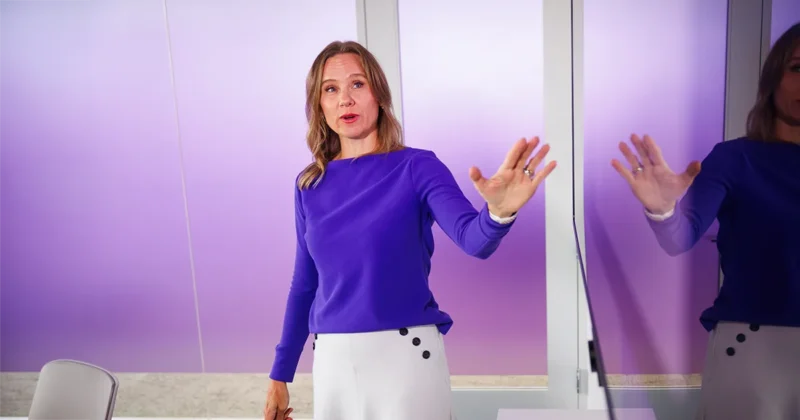 Rachel Reimer, PhD, MS, points at a digital screen while providing course instruction.