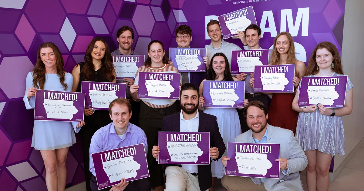 DMU College of Osteopathic Medicine students pose for a group photo on Match Day, holding “I Matched!” signs to celebrate residency matches in Iowa.