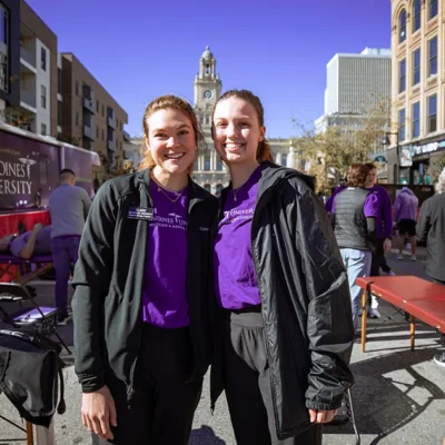 DMU students volunteer at the IMT Des Moines Marathon recovery zone, supporting runners in downtown Des Moines.
