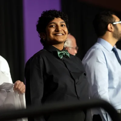 DMU students stand on stage during the White Coat Ceremony, marking the beginning of their medical education.