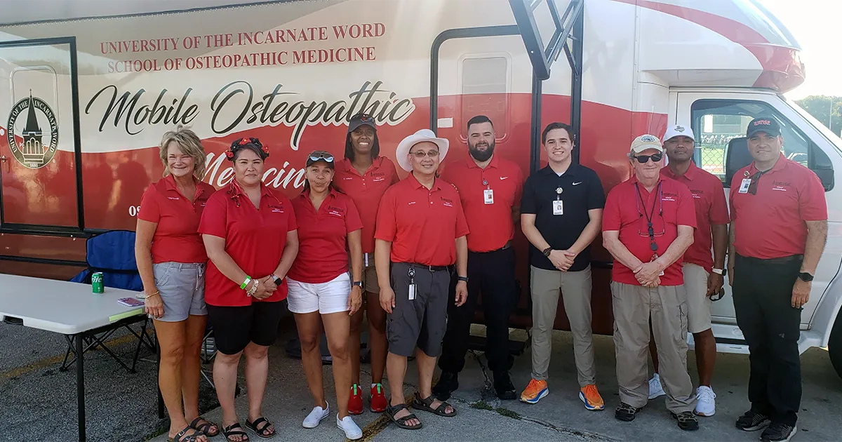 John T. Pham, DO’00, FACOFP, stands with colleagues in front of the University of the Incarnate Word School of Osteopathic Medicine Mobile Osteopathic Medicine clinic vehicle.