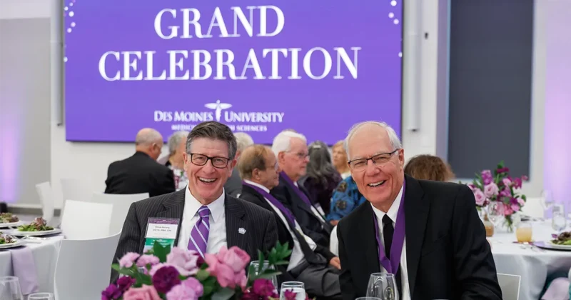 Two DMU alumni from the class of 1976 pose for a photo at the 2026 Grand Celebration event.
