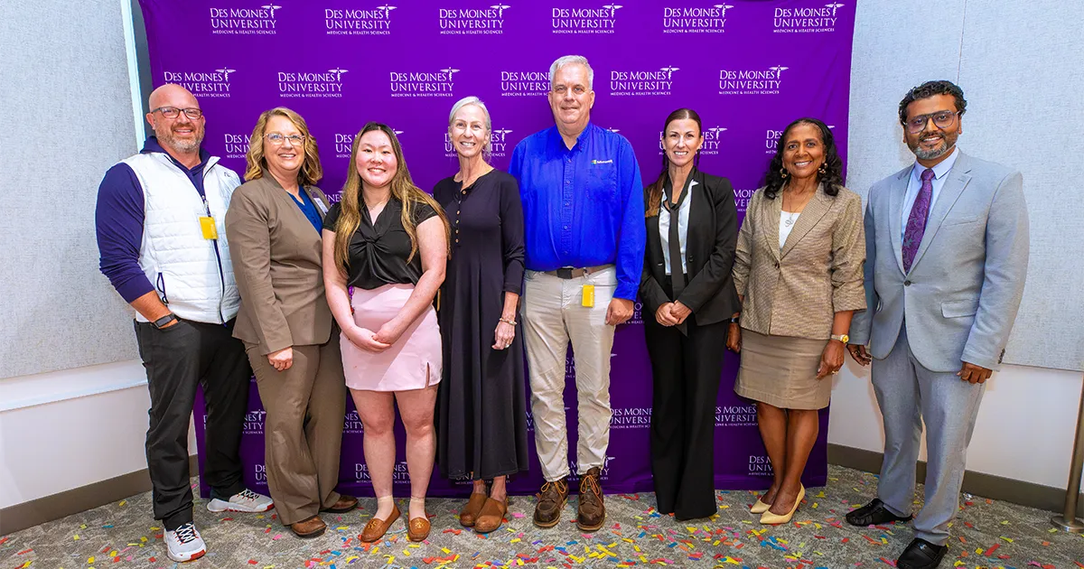 Innovation Tank participants, judges and organizers pose for a group photo in front of a Des Moines University Medicine and Health Sciences backdrop following the 2026 competition.