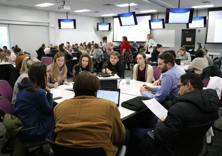 An interprofessional education session, involving a pediatrics case, is held on campus for students from DMU, Mercy College of Health Sciences, Drake University and Grandview University. Pictured in the foreground is a table of DMU students in the D.O., PA and D.P.M. programs.(DMU photo by Brett T. Roseman)