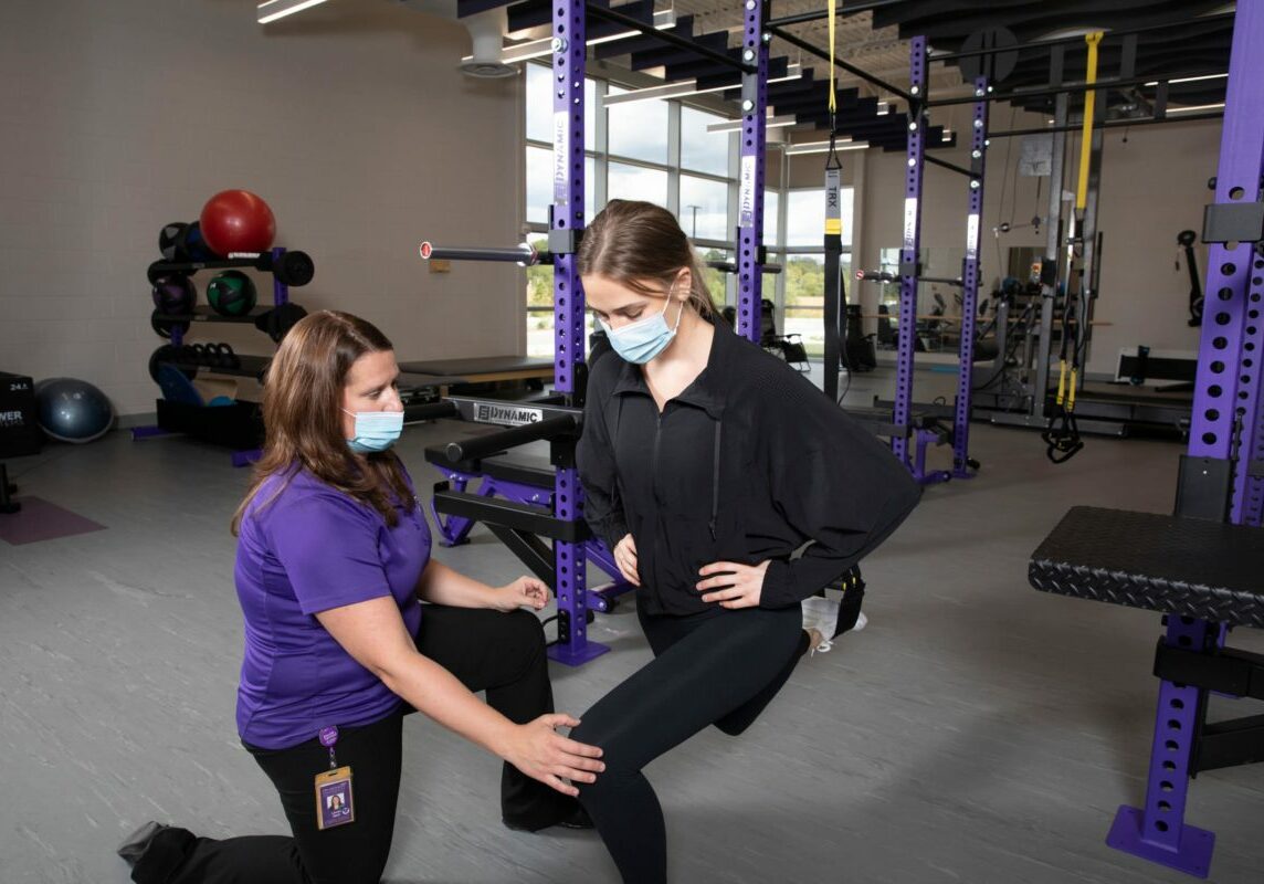 Physical therapist and head athletic trainer Lauren Mach, P.T., D.P.T., ATC, works with students at the DMU Clinic Physical Therapy location in the MidAmerican Energy Company RecPlex Tuesday, September 21, 2021. (DMU Photo by Brett T. Roseman)